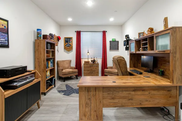 a bedroom with furniture and a flat screen tv