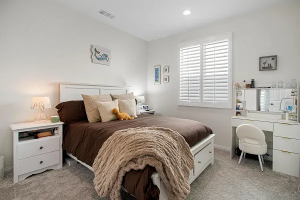a bed room with a bed and a table