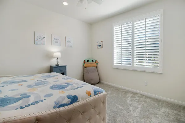 a bedroom with a bed and window