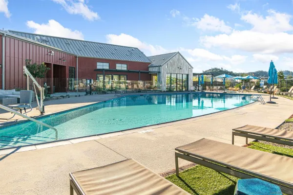 a view of a house with swimming pool and a yard