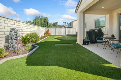 a view of kitchen with microwave refrigerator dining table and chairs