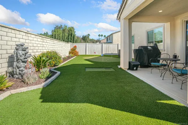 a view of a backyard with sitting area