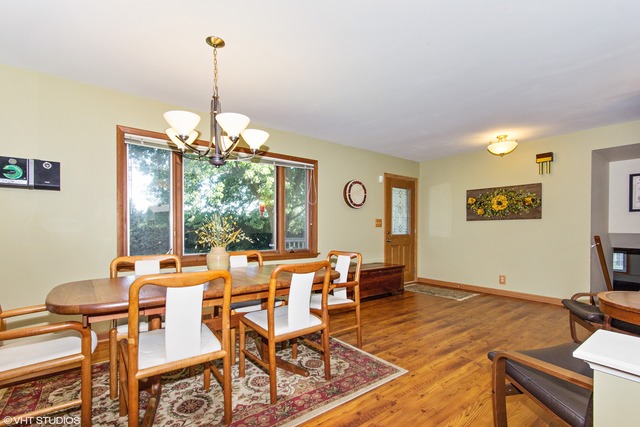 2541 Little Rock Road Plano, IL 60545 - Photo 2 of 13 a view of a dining room with furniture wooden floor and a chandelier