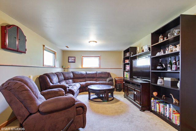 2541 Little Rock Road Plano, IL 60545 - Photo 4 of 13 a living room with furniture and a flat screen tv