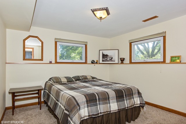 2541 Little Rock Road Plano, IL 60545 - Photo 10 of 13 a bedroom with a bed and a painting on the wall