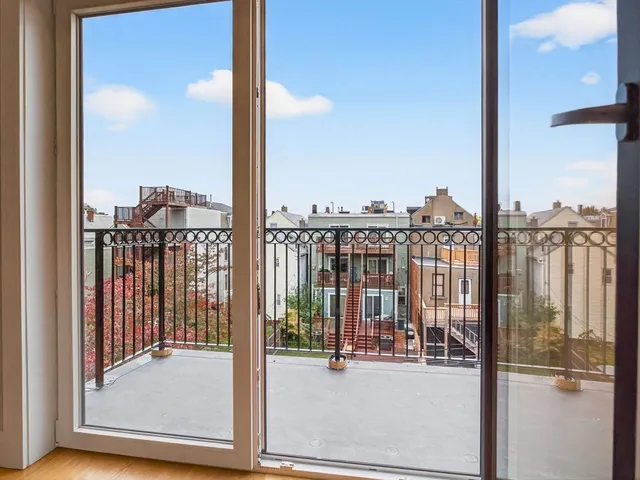a view of a balcony with floor to ceiling window