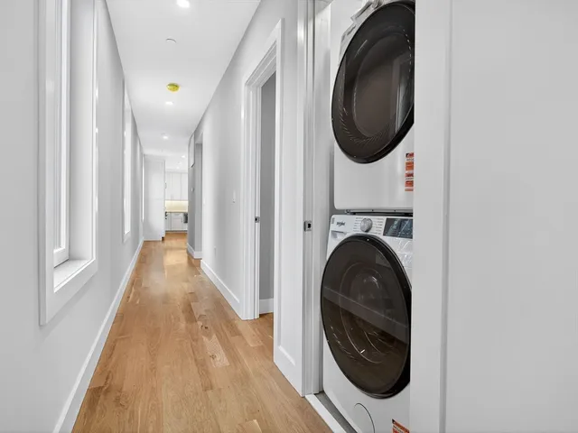 a view of a hallway with washer and dryer