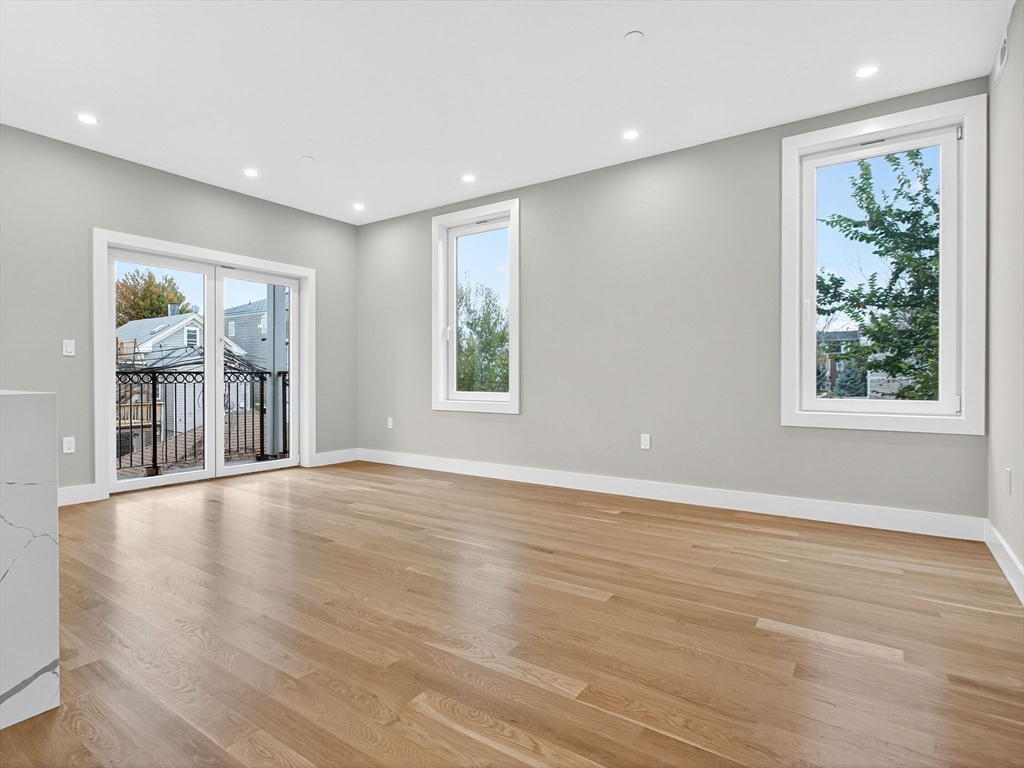 551 East 7th Street, Unit 3 Boston, MA 02127 - Photo 4 of 15 a view of an empty room with wooden floor and a window