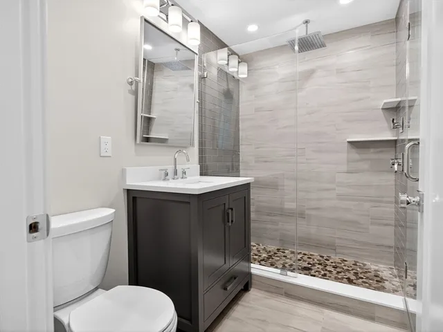 a bathroom with a sink toilet and shower