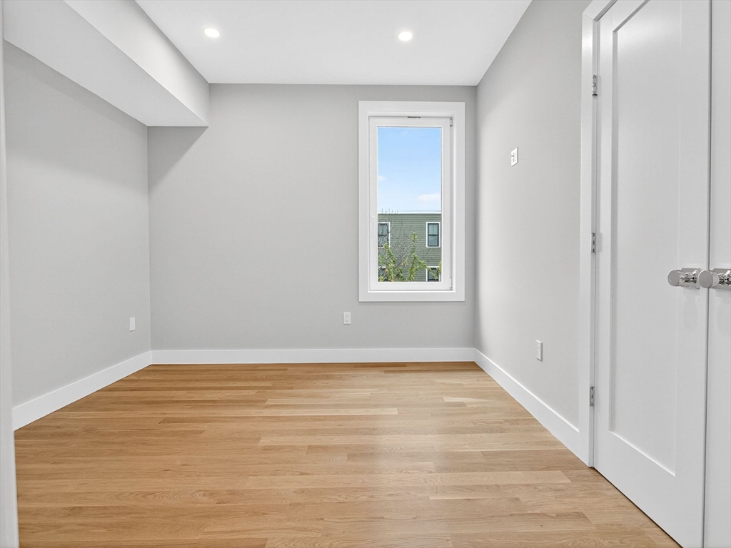 551 East 7th Street, Unit 3 Boston, MA 02127 - Photo 10 of 15 a view of an empty room with wooden floor and a window