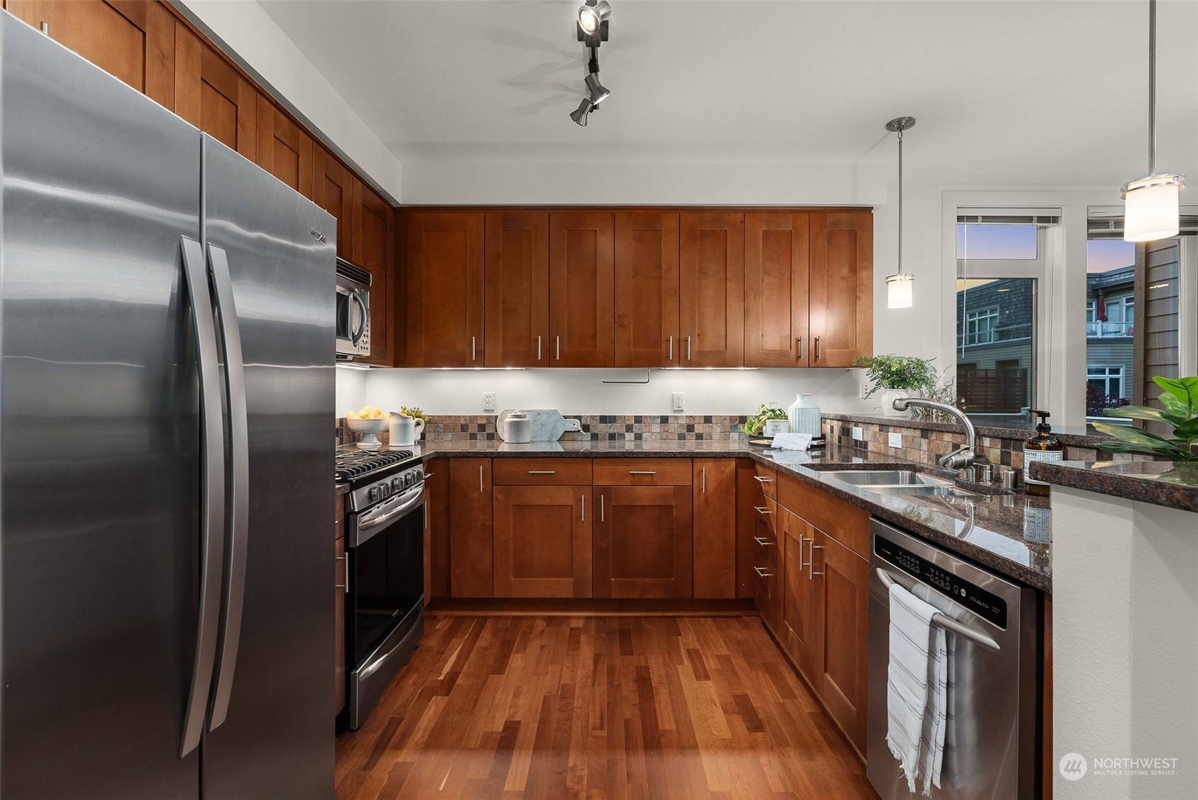 75 Pine Street, Unit 204 Edmonds, WA 98020 - Photo 17 of 30 a kitchen with granite countertop stainless steel appliances and wooden cabinets