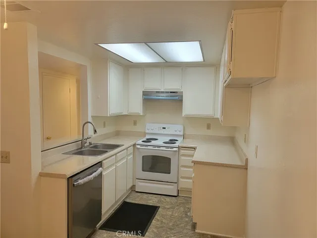 a white stove top oven sitting inside of a kitchen