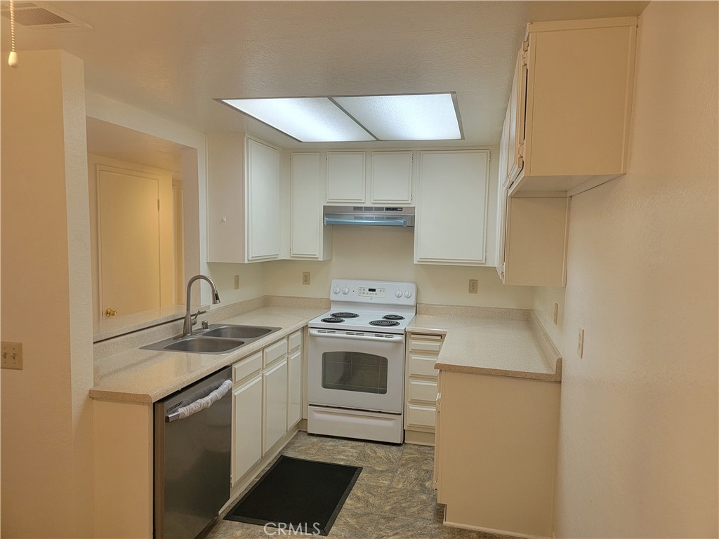 435 West 9th, Unit A7 Upland, CA 91786 - Photo 4 of 13 a white stove top oven sitting inside of a kitchen