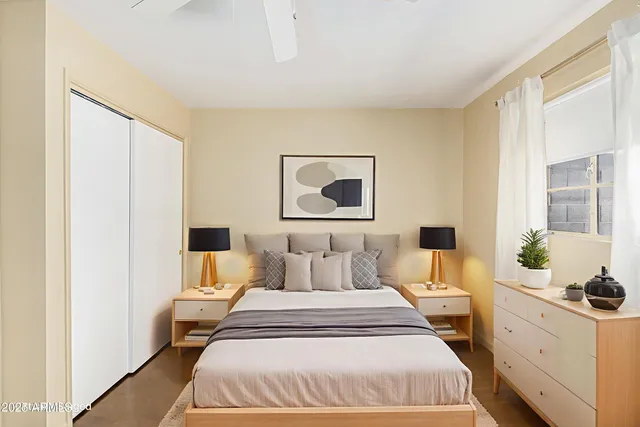 a spacious bedroom with a bed and a window