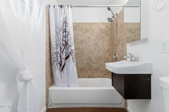 a bathroom with a bathtub and shower