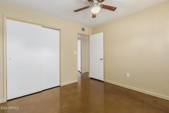 an empty room with a empty space and a ceiling fan