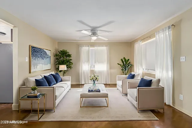 a living room with furniture and a large window