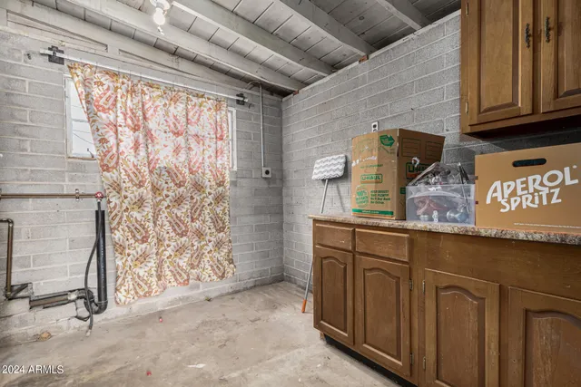 a bathroom with a granite countertop sink and a shower