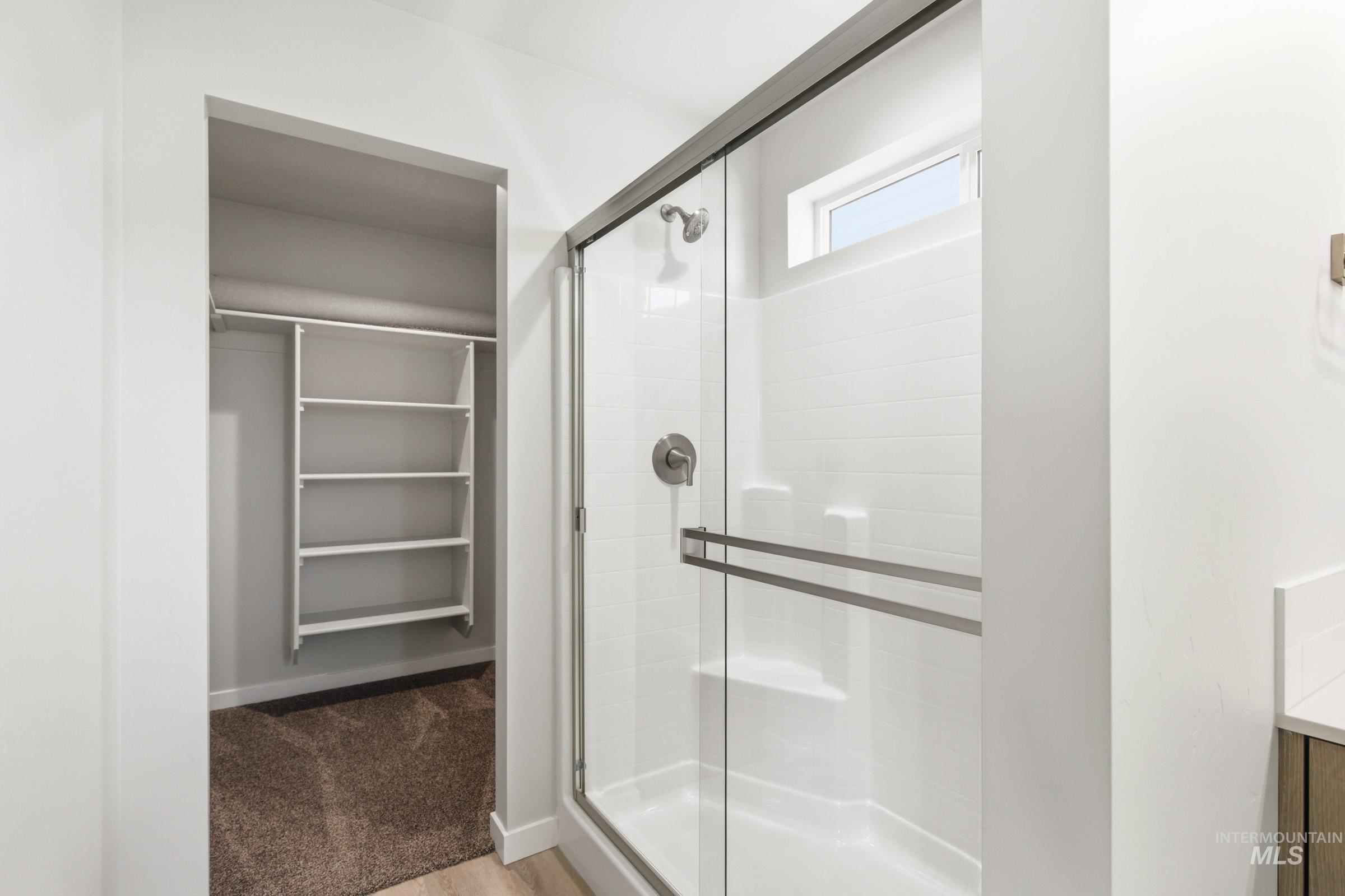 10806 Rutland Street Caldwell, ID 83605 - Photo 19 of 21 Shower with clear glass enclosure and a white subway tile surround