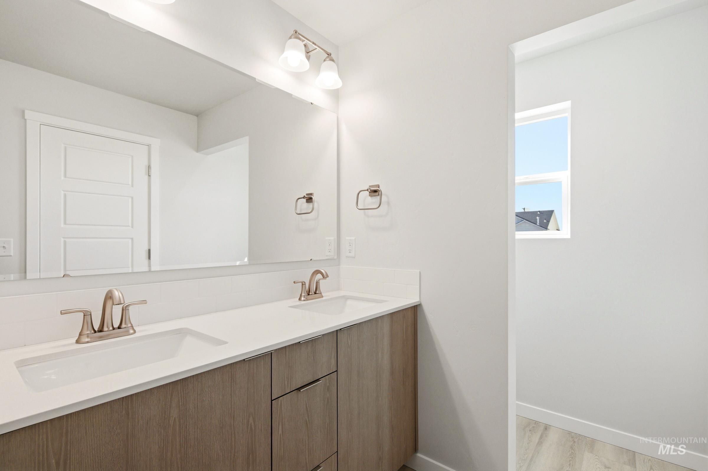 10806 Rutland Street Caldwell, ID 83605 - Photo 20 of 21 Dual vanity with undermount sinks, brushed nickel faucets, and a broad mirror