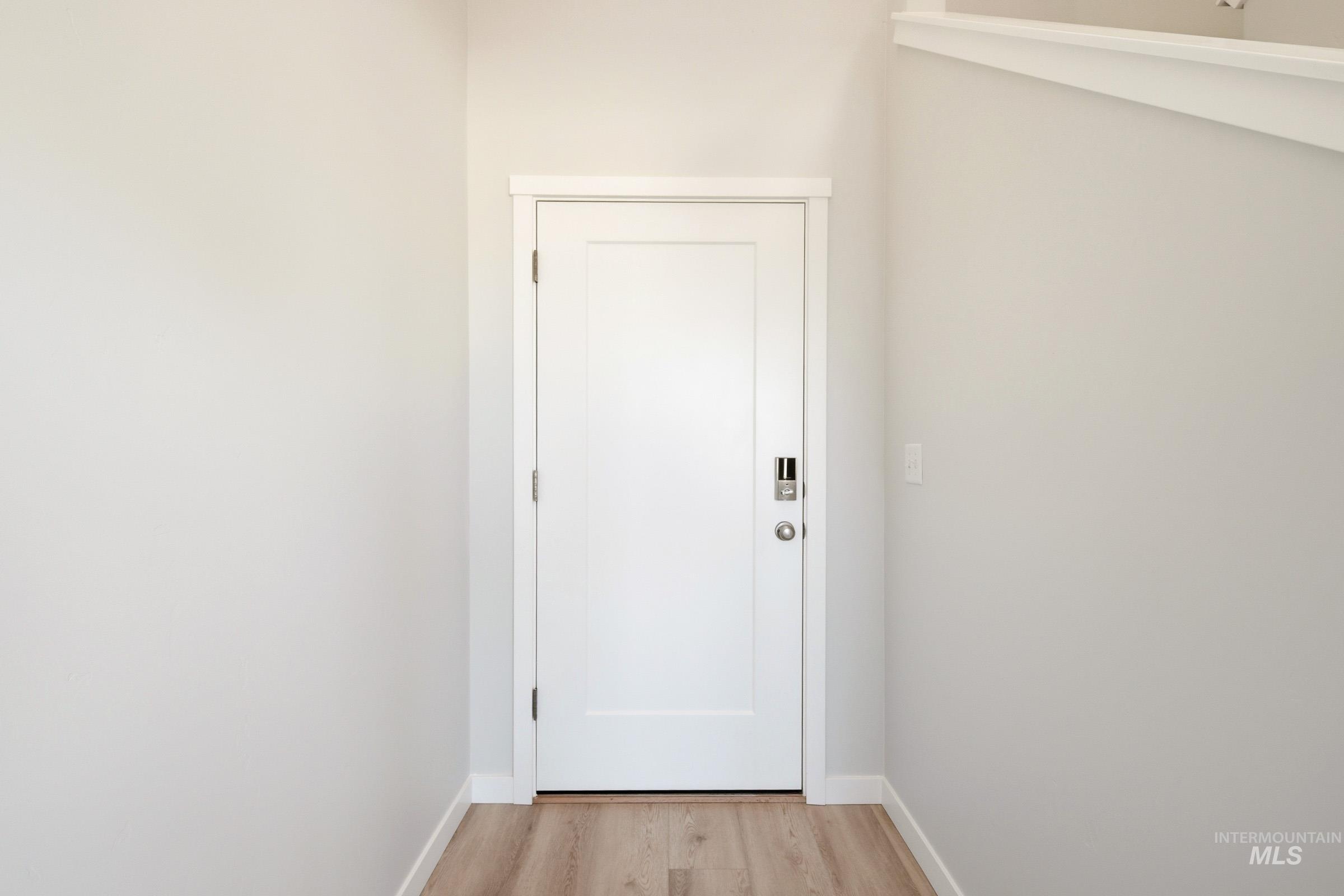 10806 Rutland Street Caldwell, ID 83605 - Photo 2 of 21 Entryway featuring a white paneled door with modern hardware, including a digital keypad