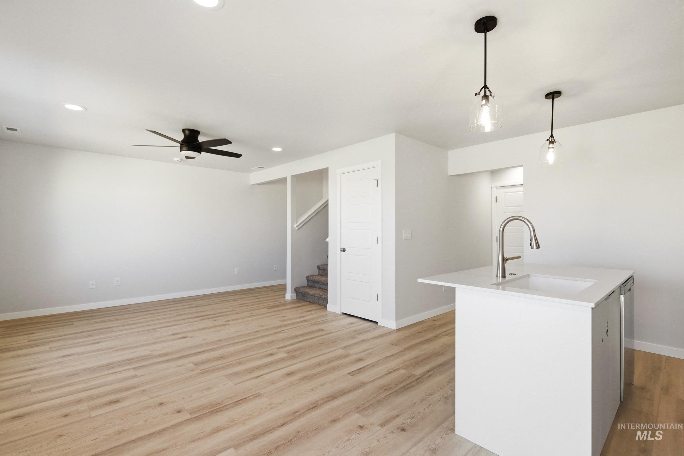 10806 Rutland Street Caldwell, ID 83605 - Photo 8 of 21 Open-concept living area featuring wood-finish flooring, recessed lighting, and a ceiling fan