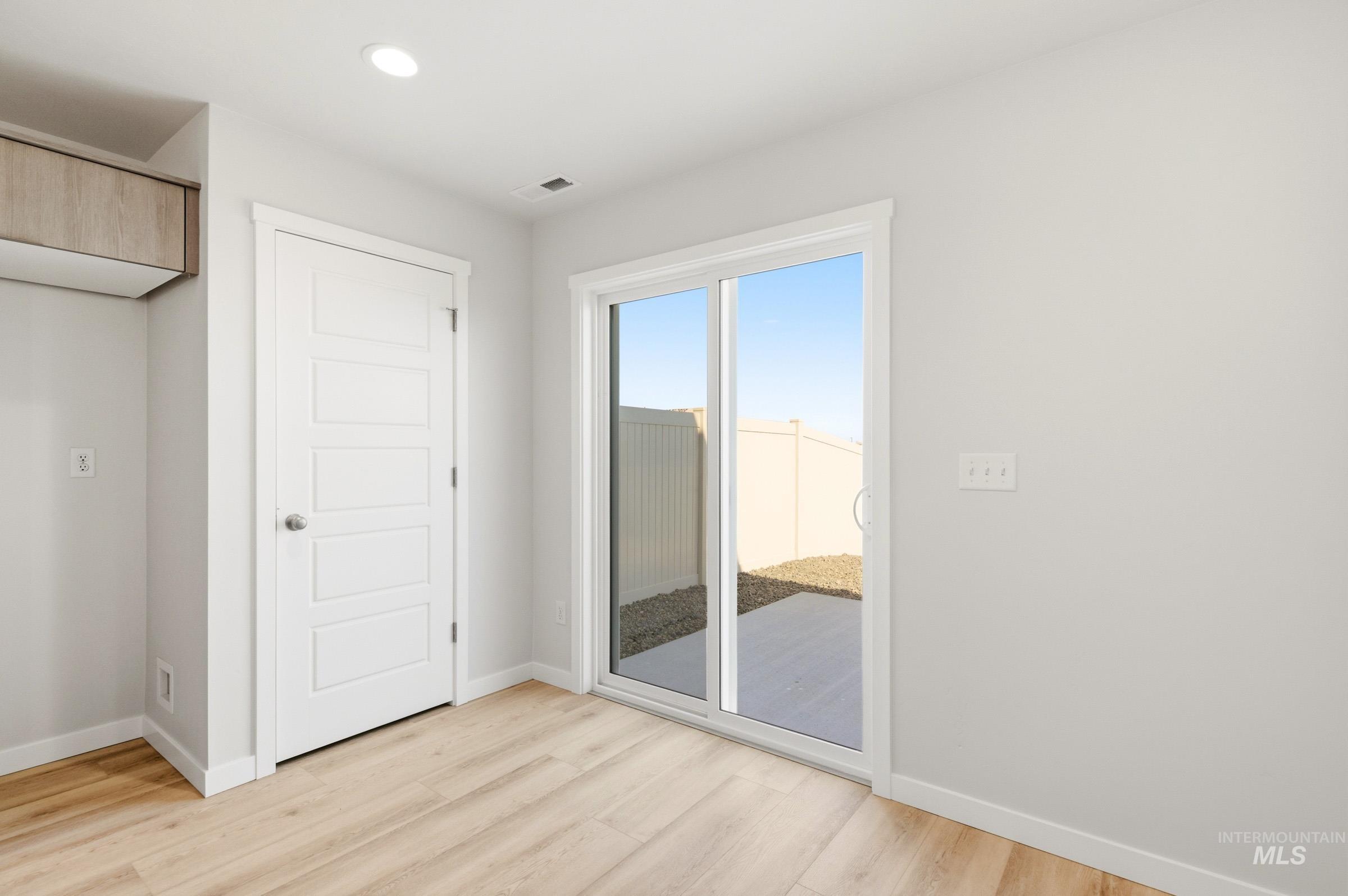 10806 Rutland Street Caldwell, ID 83605 - Photo 9 of 21 Sliding glass door leading to an outdoor area with a concrete patio