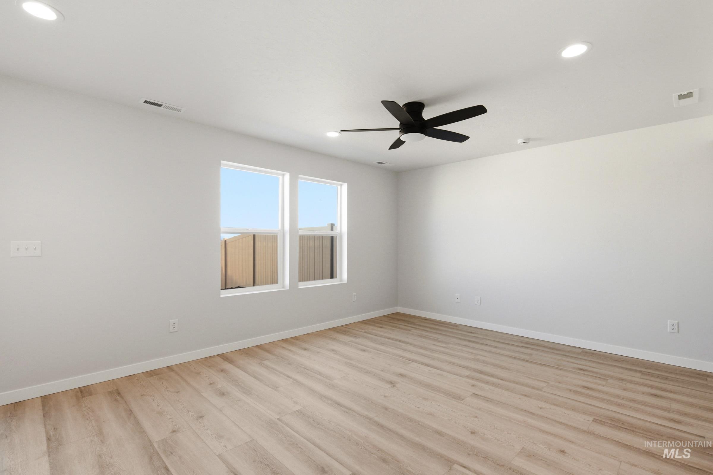 10806 Rutland Street Caldwell, ID 83605 - Photo 10 of 21 Spacious room featuring wood-finish flooring, recessed lighting, and a contemporary ceiling fan