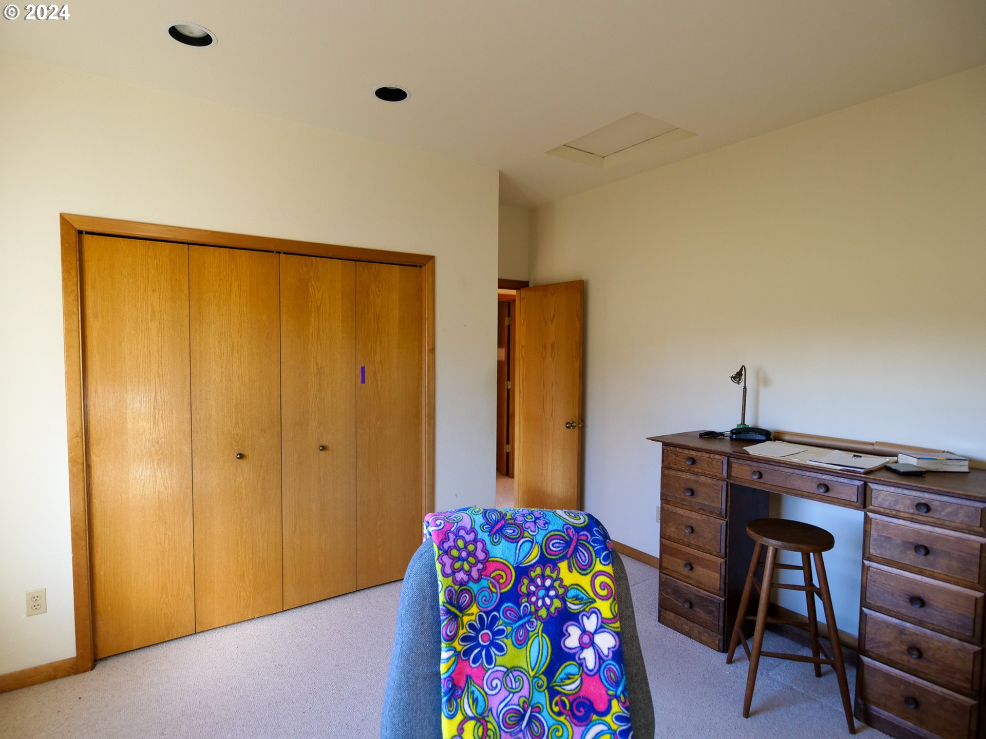 19107 Northwest Logie Trail Road Portland, OR 97231 - Photo 19 of 46 a bedroom with a bed and a dresser