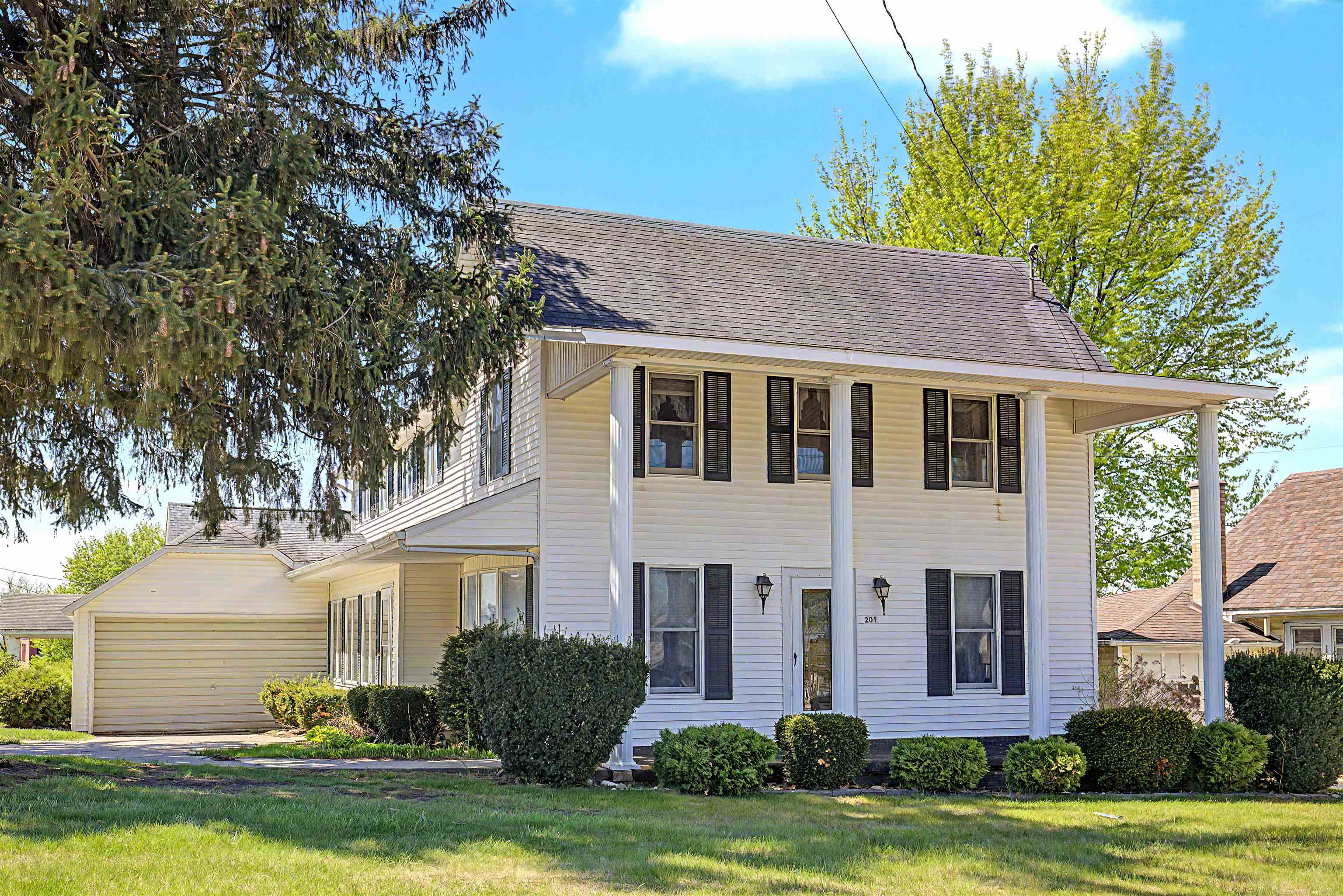 201 West Main Street Elizabeth, IL 61028 - Photo 1 of 34 a front view of a house with a garden and plants