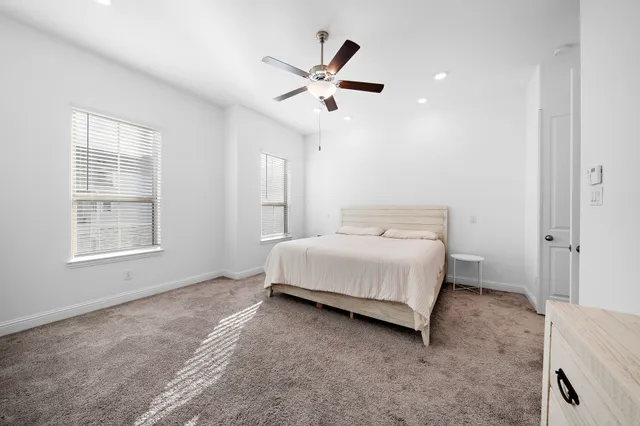 a spacious bedroom with a bed and window
