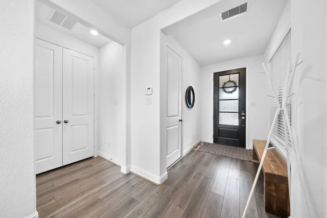 a view of hallway with wooden floor