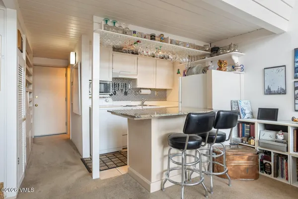 a kitchen with cabinets and chairs