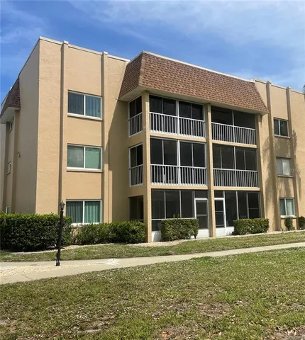 a front view of a building with a garden