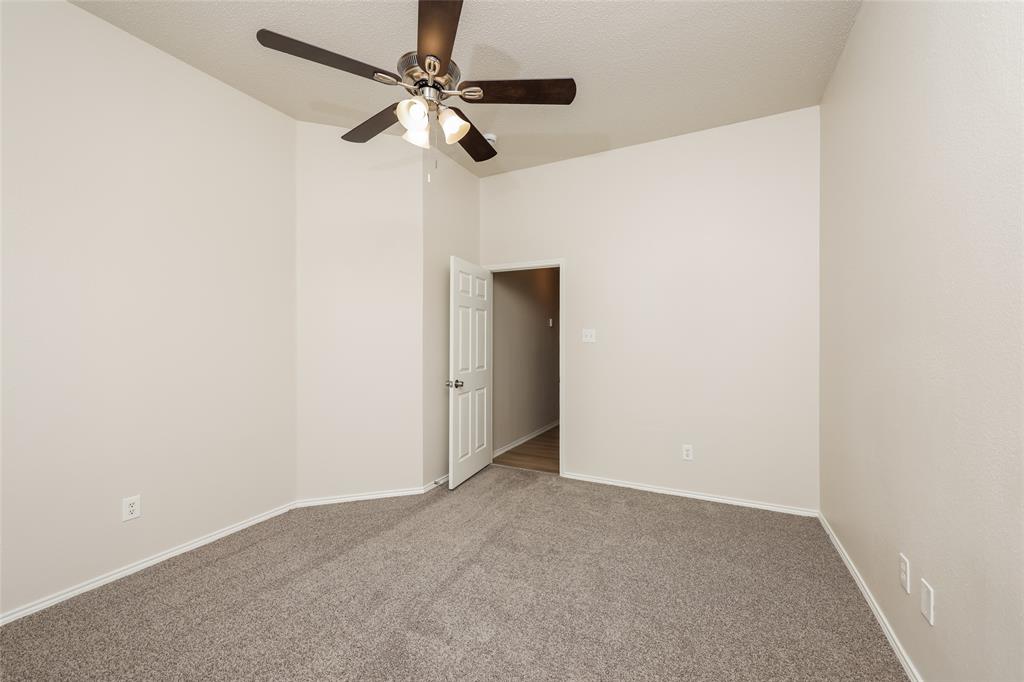 328 Willow Creek Drive Glenn Heights, TX 75154 - Photo 10 of 16 an empty room with a fan & a ceiling fan
