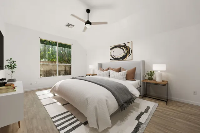 a bedroom with a bed and a window