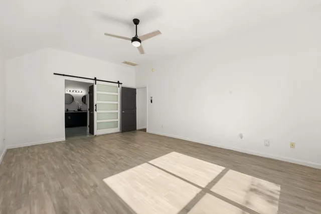 a view of a big room with closet and windows