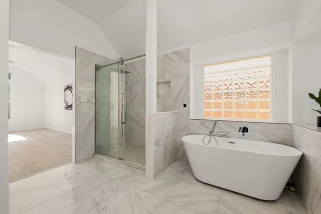 a bathroom with a bathtub and shower