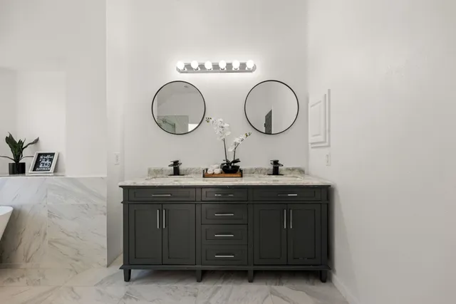a bathroom with a double vanity sink and a mirror