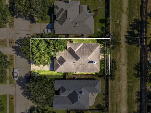 an aerial view of a house with a yard