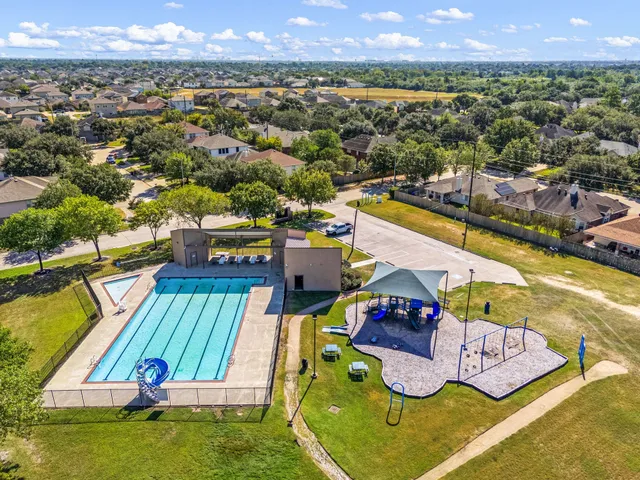 an aerial view of a house with a swimming pool