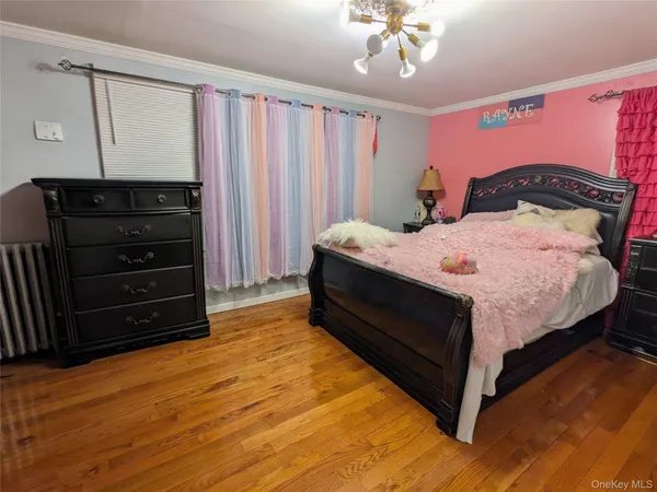 a bed sitting in a spacious bedroom next to a window
