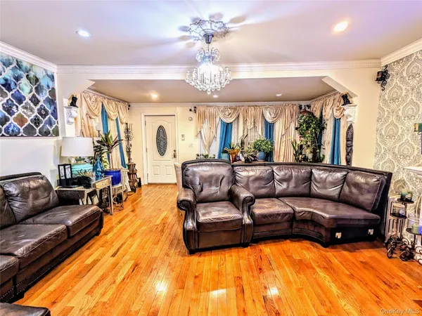a living room with furniture and a chandelier