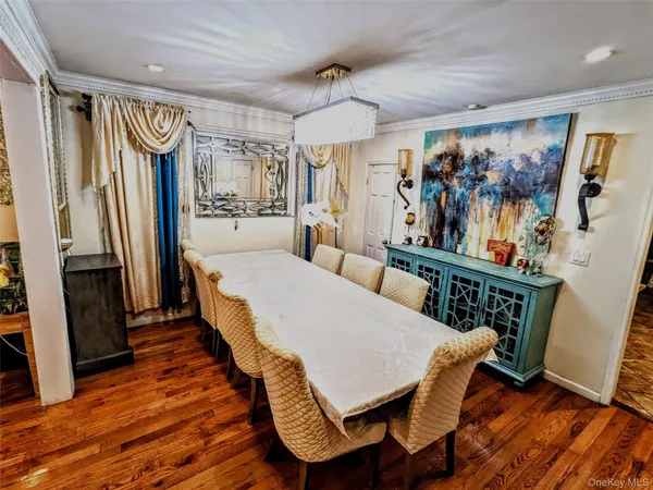 a view of a dining room with furniture wooden floor and a chandelier