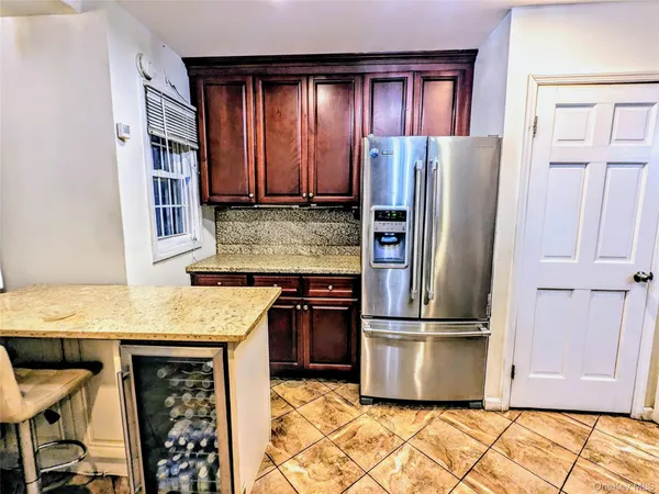 a kitchen with stainless steel appliances granite countertop a refrigerator a stove and a refrigerator with wooden floor