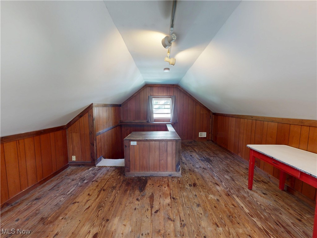 1136 Erieview Road Cleveland Heights, OH 44121 - Photo 36 of 45 Additional living space with dark wood-style floors, vaulted ceiling, and wood walls