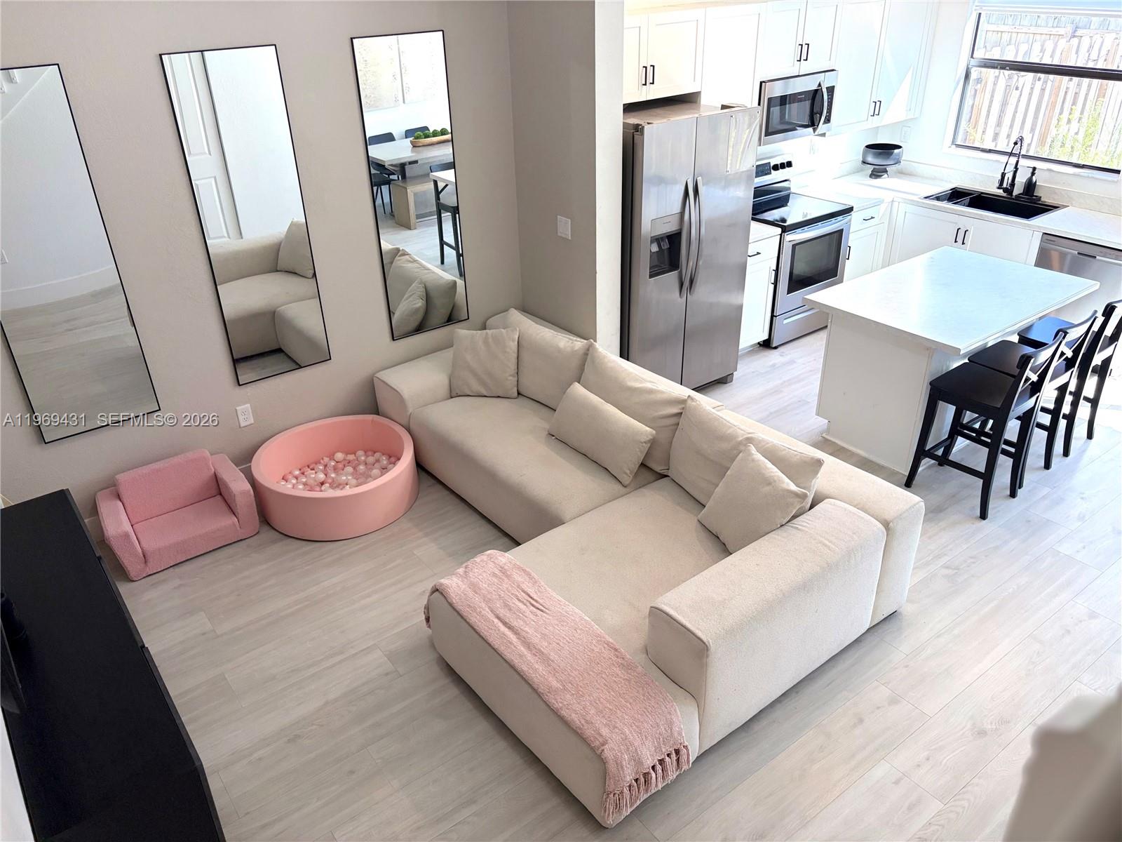 14724 Southwest 181st Terrace Miami, FL 33187 - Photo 11 of 36 a living room with furniture and wooden floor