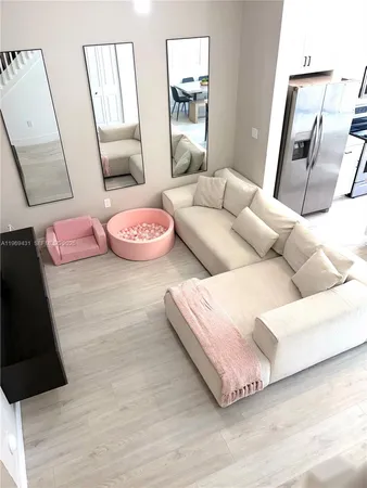 a bedroom with furniture and a large mirror