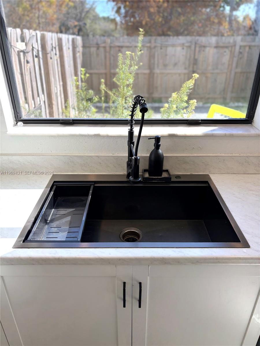 14724 Southwest 181st Terrace Miami, FL 33187 - Photo 14 of 36 a close view of sink and a microwave oven