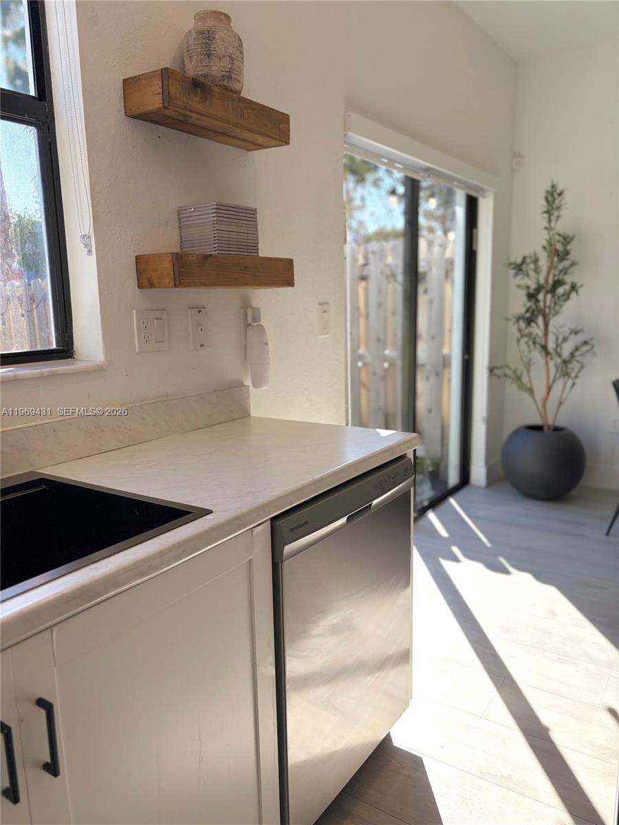 14724 Southwest 181st Terrace Miami, FL 33187 - Photo 15 of 36 a kitchen with a refrigerator and a sink
